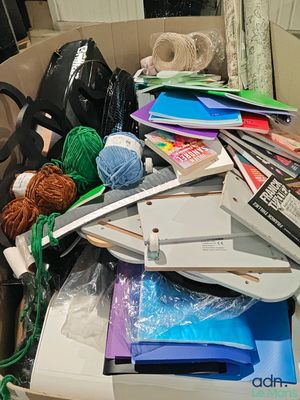 a box full of books and other items on the floor