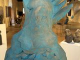 a sculpture of a bird on a pedestal in a museum