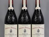three bottles of red wine sitting on a table next to each other