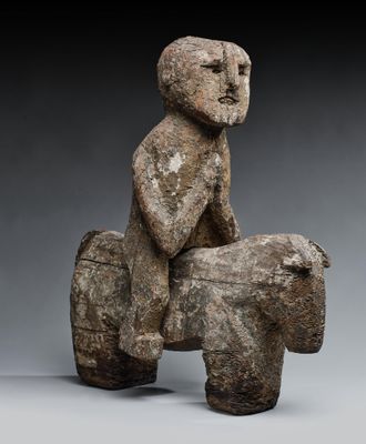 an image of a sculpture of a man sitting on top of a rock