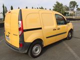 a small yellow van parked in a parking lot