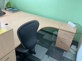 a desk with a chair and a computer on it