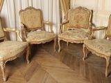 four chairs and a cabinet in a room