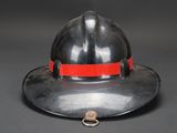 a close up of a fireman ' s hat with a red band