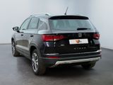 the rear end of a black suv parked in a white room