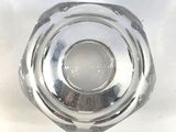a clear glass vase with a small hole in it