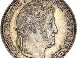 gros plan d'une pièce de monnaie sur laquelle figure un visage de femme