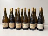 six bottles of wine lined up in a row on a table