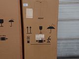 two cardboard boxes stacked on a pallet in front of a garage door