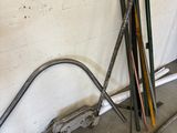 a pile of skis and poles in a garage