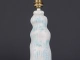 a blue and white ceramic bottle lamp with a cord attached to it
