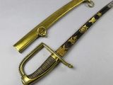 a close up of a knife with a gold handle on a white surface