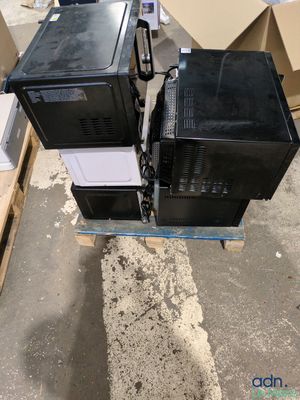 two televisions sitting on top of a pallet in a warehouse