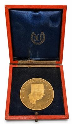 a close up of a gold coin in a red case