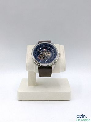 a watch sitting on a display stand on a white surface