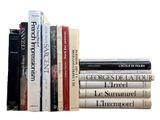 a lot of books that are stacked on top of each other