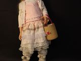 a doll that is standing next to a basket and shoes