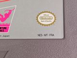 an old nintendo game on the wall with a sticker on it