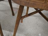 a close up of a wooden chair with a wooden seat