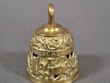 a gold bell that is sitting on a table