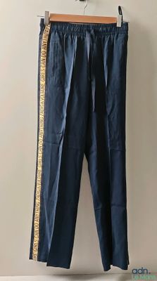 blue pants hanging on a hanger in a room with a white wall