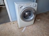 a washing machine sitting on the floor next to a door