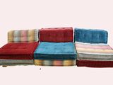 a picture of a set of four couches with colorful cushions
