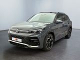 a grey volkswagen suv parked in a room with a black floor