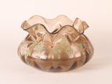 a glass vase that is sitting on a white surface