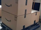 boxes stacked on a pallet in a warehouse with arrows pointing up