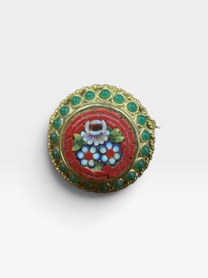 an image of a broochle with grapes on it on a white surface