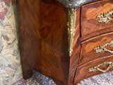 a marble top chest of drawers on a rug