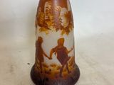 a brown vase with a picture of a boy and a girl on it