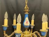a blue and gold chandelier with five candles on it