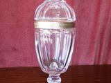a glass jar with a gold lid on a wooden table