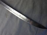 a large knife that is laying on a table