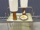 a table with two lamps and a plate on it