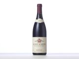 a bottle of red wine sitting on top of a table