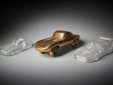 three plastic toy cars sitting next to each other on top of a table