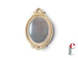 a gold oval mirror on the wall with a white background