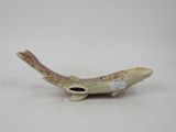 a small figurine of a fish with a hole in it