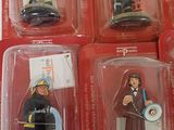 six action figures of a fireman in plastic cases