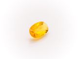 a yellow sapphire stone on a white background