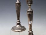 pair of silver candlesticks on clear acrylic stand