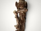 an image of a bronze statue of a man holding a trumpet