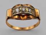 an image of a gold ring with three diamonds on top of it