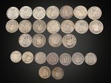 a group of silver coins on a black background