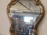 a mirror that is sitting on a table in a room