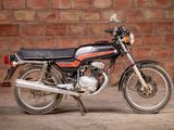 a motorcycle that is parked in front of a brick wall