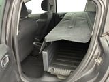 a car with the back door open and the back seat folded down